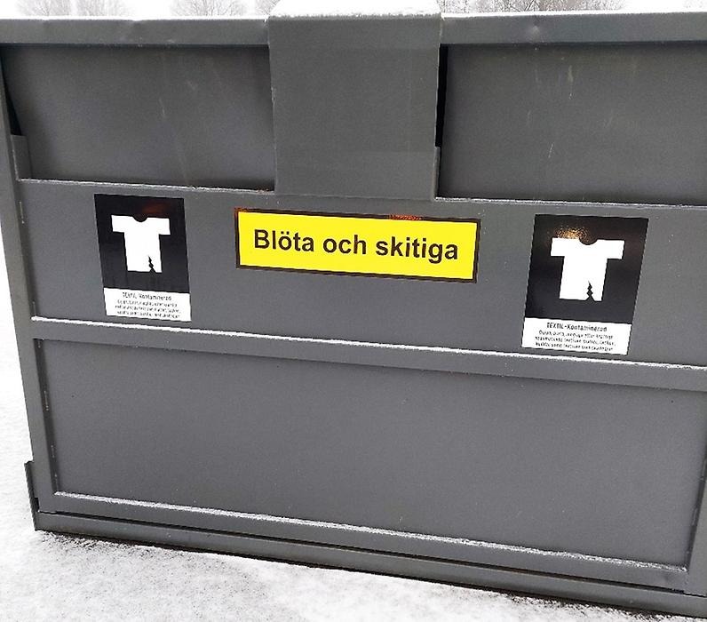 Kontaminerad textilavfallsbehållare
